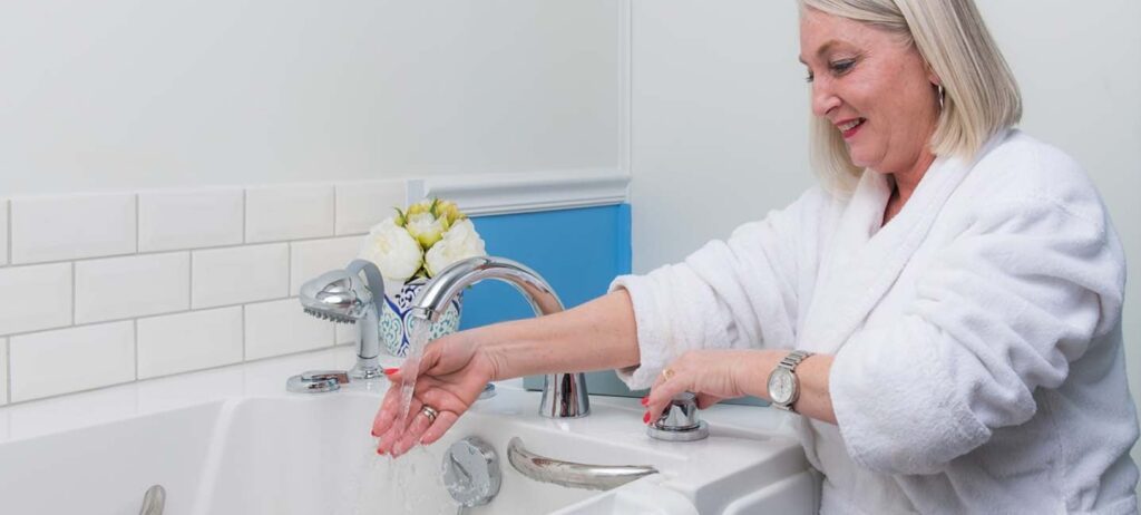 Woman filling her walk-in tub with a rapid fill faucet