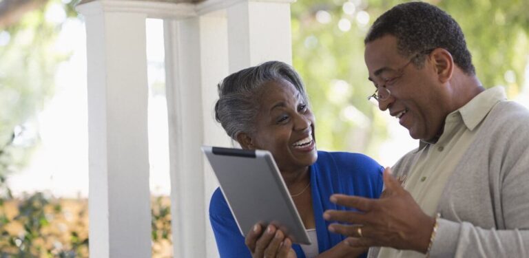 couple researching walk-in tubs on their tablet