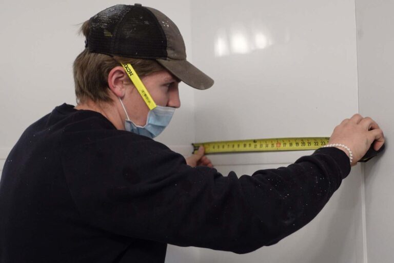 installer measuring the tub space