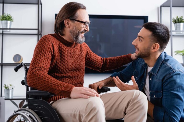 man in wheelchair speaking to his son