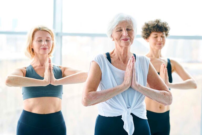 three women doing yoga