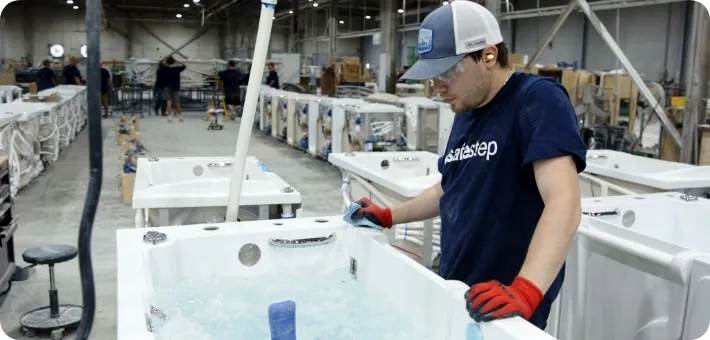 Man examining the walk-in tub in a Safe Step warehouse