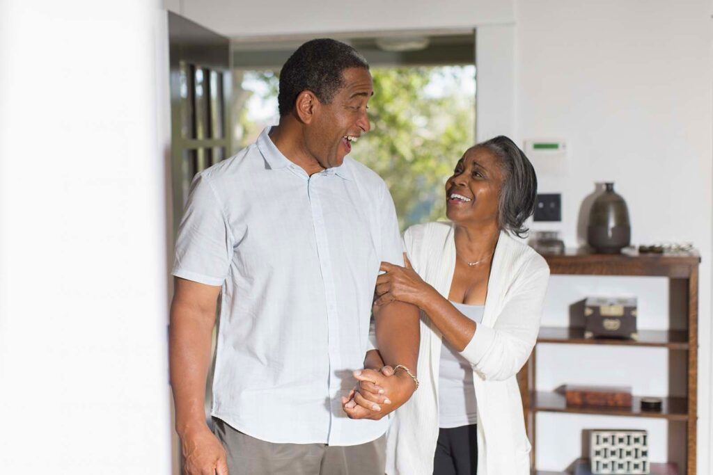 elderly couple linking arms
