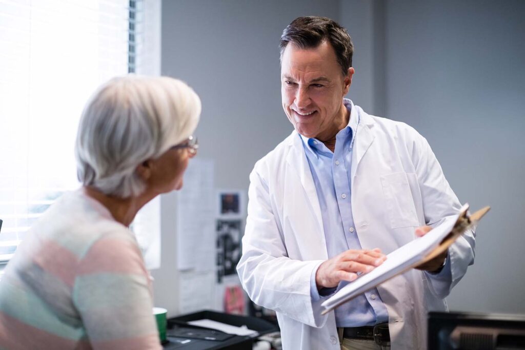 doctor show elderly patient her chart