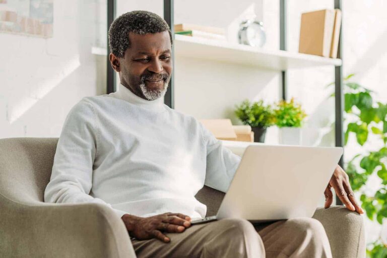 a man on his laptop researching walk-in tubs