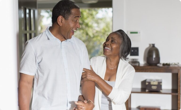 old couple holding hands and laughing