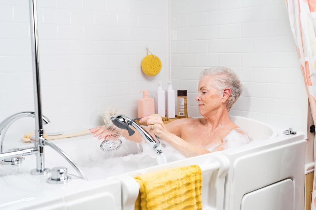 woman using the handheld shower wand